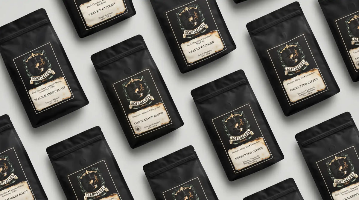 Diagonal repeating pattern of four Scandalous Coffee varieties in black bags on a light grey surface.